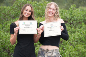 Two young people stand with their scholarship awards at a Tahoe Truckee scholarship reception.