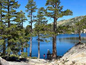 Father and children backpacking in the mountains of California