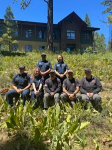North Tahoe Fire District team sitting on a hillside in front of the firehouse
