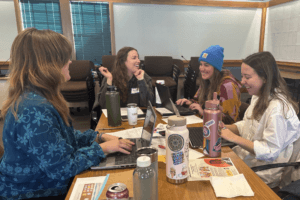 4 women at at a conference table collaborating to bring impact to tahoe truckee