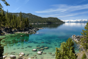 A bay in Lake Tahoe with emerald green waters and sunny skies
